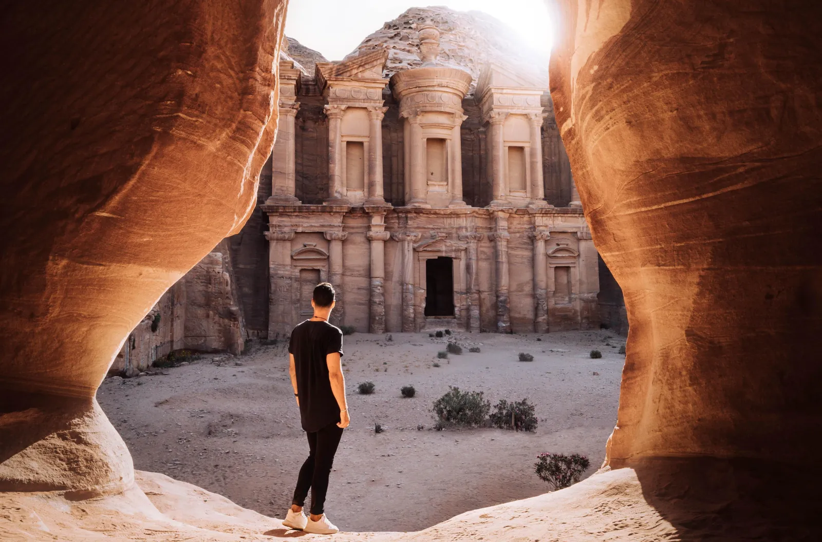 The Monastery framed by a natural rock arch on the ridge above Petra