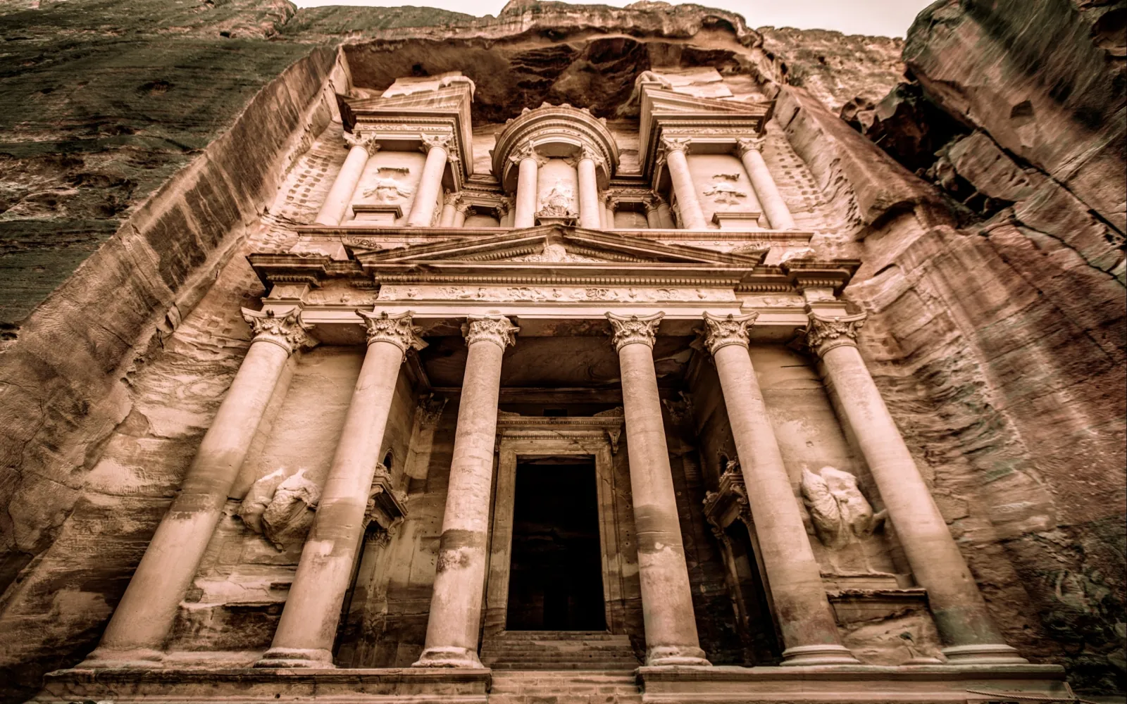 Columns and pediment of the Treasury at Petra in flat daylight